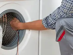 Dryer repair technician diagnosing and servicing a clothes dryer in Pembroke Pines, FL