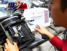 Vacuum repair technician servicing internal components on a workbench in Pembroke Pines, FL