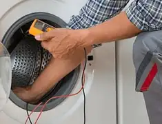 Washing machine repair technician testing a front-load washer with diagnostic tools in Pembroke Pines, FL