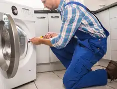 Washing machine repair technician servicing a front-load washer in Pembroke Pines, FL