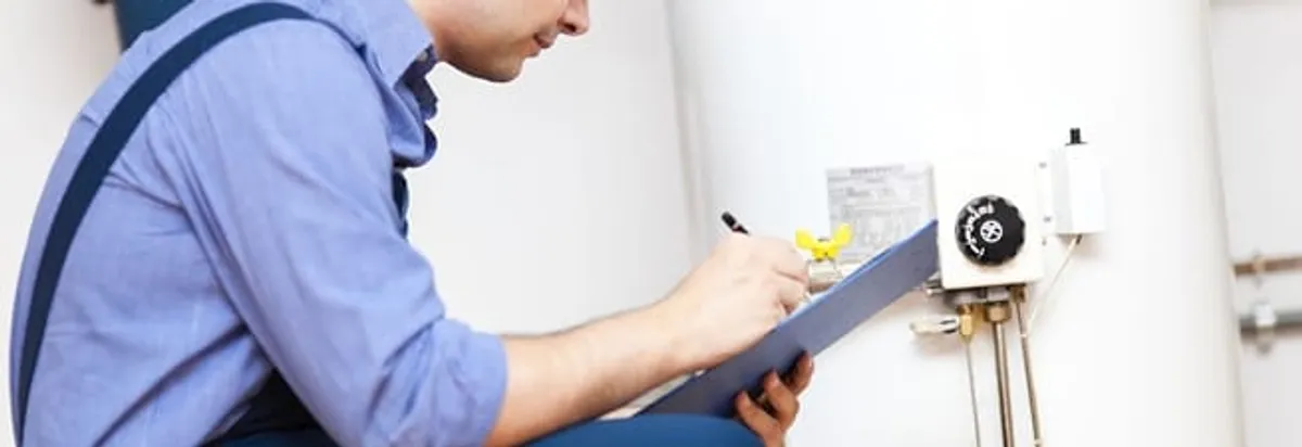 Water heater repair technician inspecting the unit and recording service notes in Pembroke Pines, FL